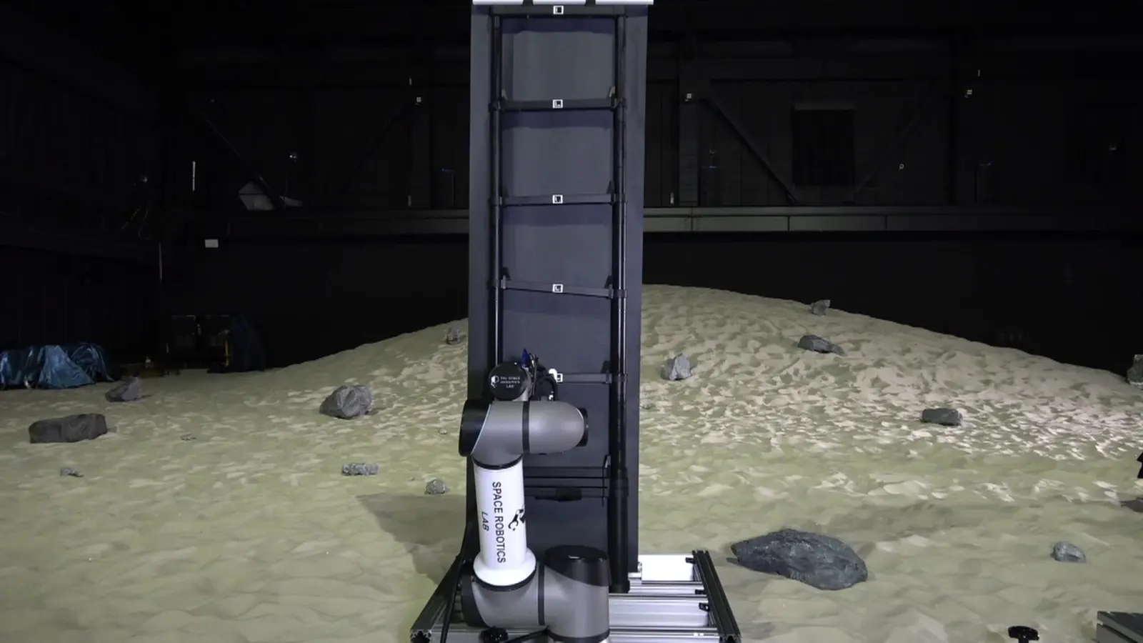 The same arm holding the fully extended solar tower.