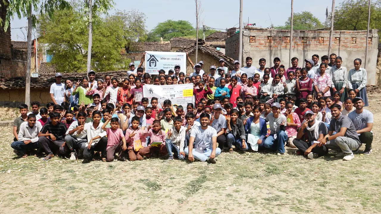 More than a hundred villagers, children and volunteers gathered around Helping Hut and GramSutr banners in Gopalpura.