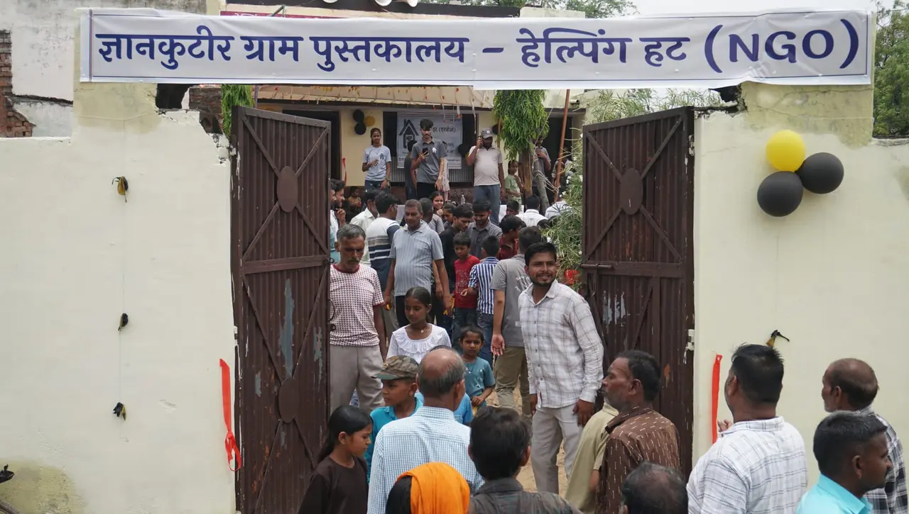 Villagers walking in under the GyanKutir banner on the library's opening day.